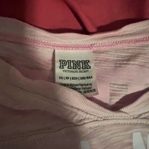 Mid length sleeves. The color is washed out pink.